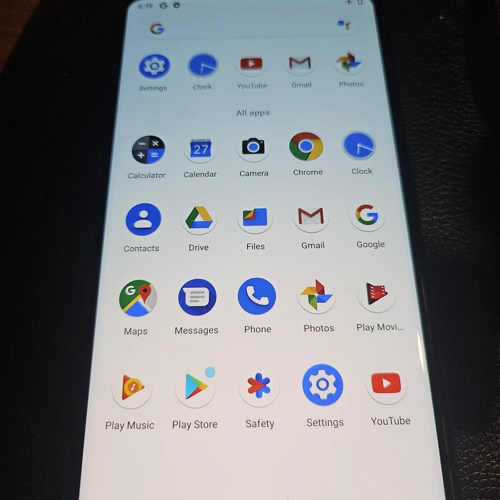 Sleek Black Smartphone with Coastal Display
